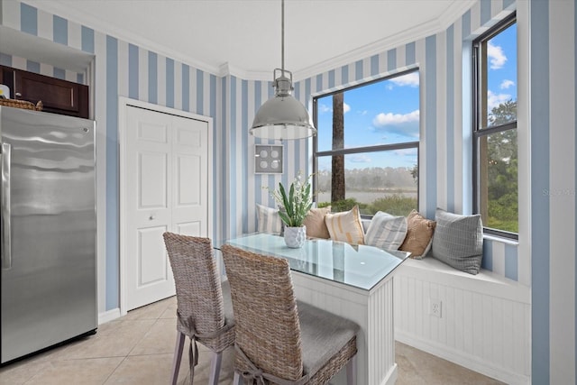 dining room with crown molding and light tile patterned flooring