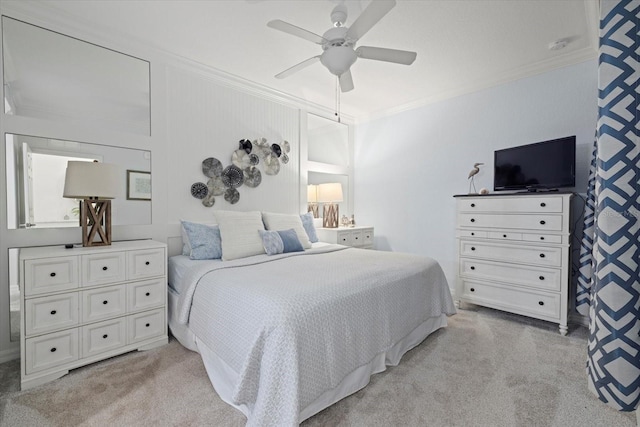 bedroom featuring ceiling fan, crown molding, and light carpet