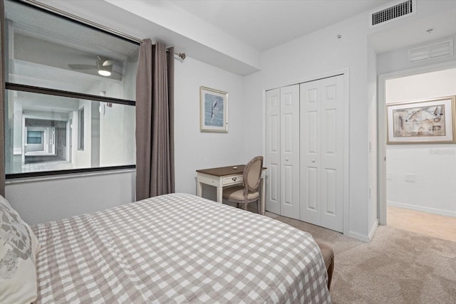 bedroom featuring a closet and light colored carpet