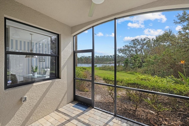 unfurnished sunroom featuring a water view