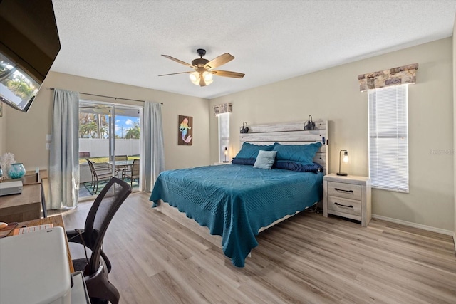 bedroom featuring ceiling fan, a textured ceiling, light wood-type flooring, and access to exterior