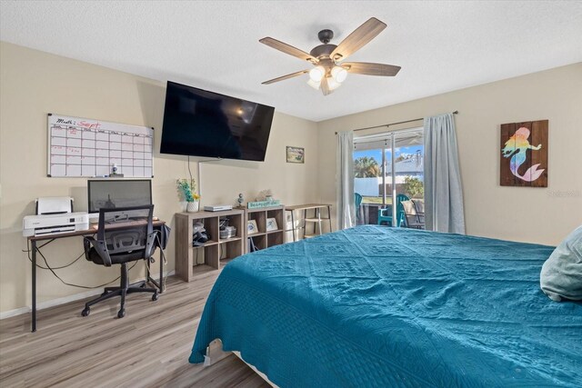 bedroom with a textured ceiling, a ceiling fan, light wood-style floors, baseboards, and access to exterior