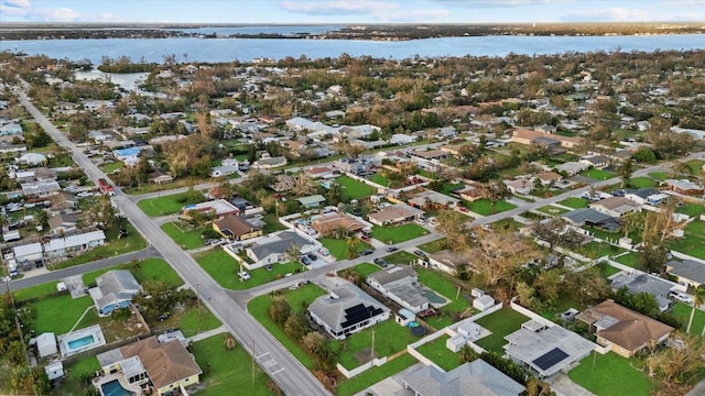 birds eye view of property with a water view and a residential view