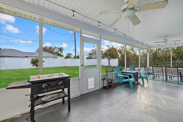 sunroom featuring ceiling fan