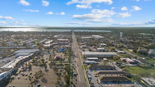 drone / aerial view featuring a view of city and a water view