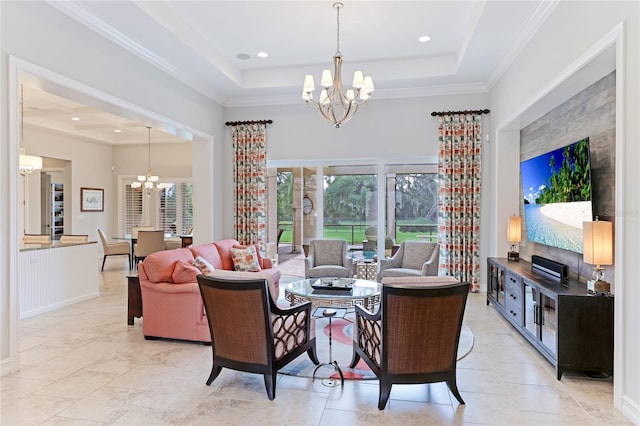 living room with crown molding, a tray ceiling, and an inviting chandelier