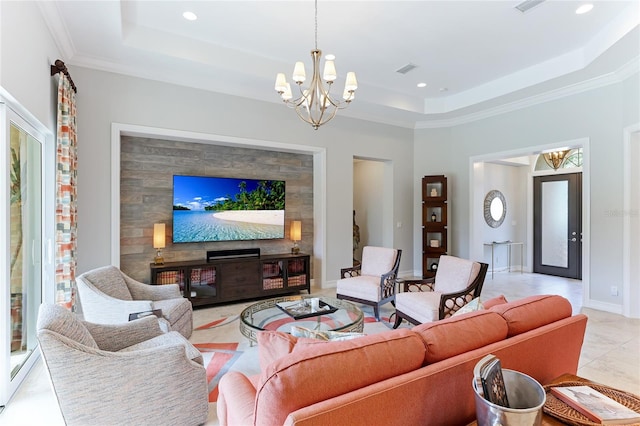 living room featuring a raised ceiling, ornamental molding, a chandelier, and light tile patterned floors