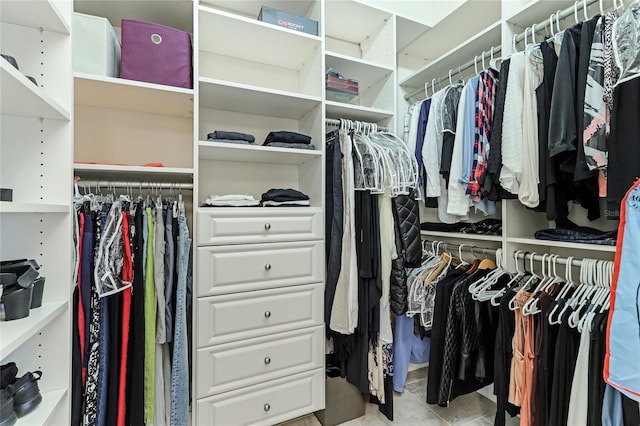 spacious closet with light tile patterned floors