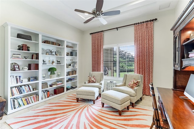 sitting room featuring light tile patterned floors and ceiling fan