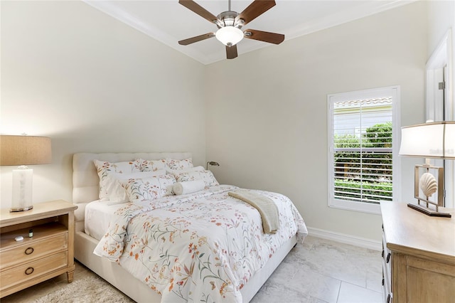 tiled bedroom with ornamental molding and ceiling fan