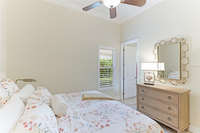 bedroom featuring crown molding, ceiling fan, and light colored carpet