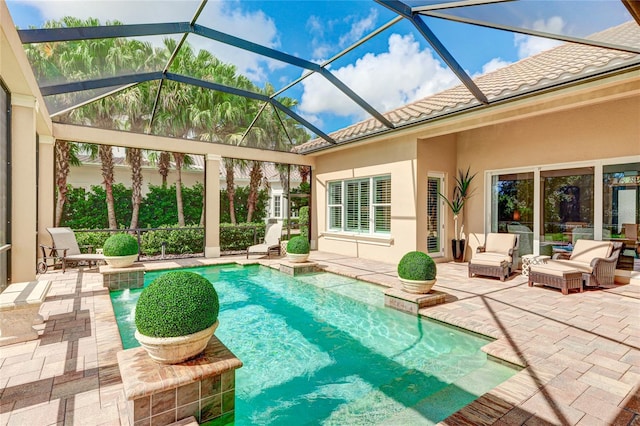 view of swimming pool featuring a patio and a lanai