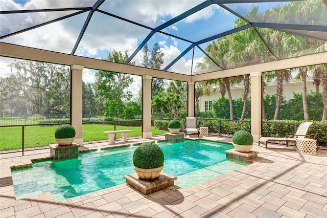 view of pool with a lanai, a patio, and pool water feature