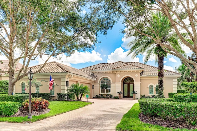 mediterranean / spanish-style home featuring a front yard