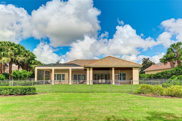 rear view of property with a lawn