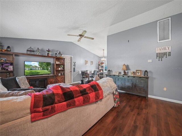 living room featuring ceiling fan, a textured ceiling, lofted ceiling, and dark hardwood / wood-style floors