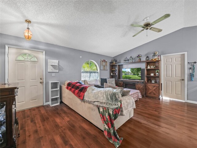 living room featuring lofted ceiling, a textured ceiling, ceiling fan, and dark hardwood / wood-style flooring