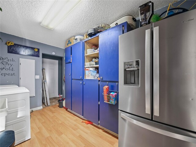 kitchen featuring stainless steel refrigerator with ice dispenser, wood-type flooring, a textured ceiling, and blue cabinetry