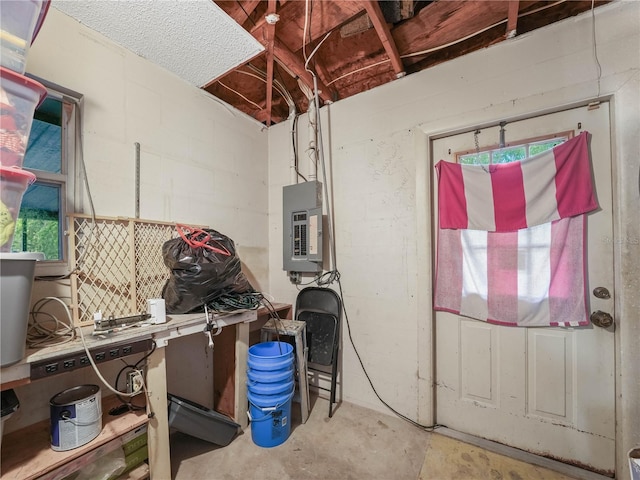 5337 Jacob Ave, Polk City, FL 33868 - miscellaneous room with concrete block wall, electric panel, and unfinished concrete floors