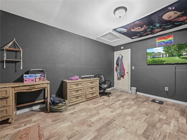 5337 Jacob Ave, Polk City, FL 33868 - office area with baseboards, light wood-type flooring, a textured wall, a textured ceiling, and attic access