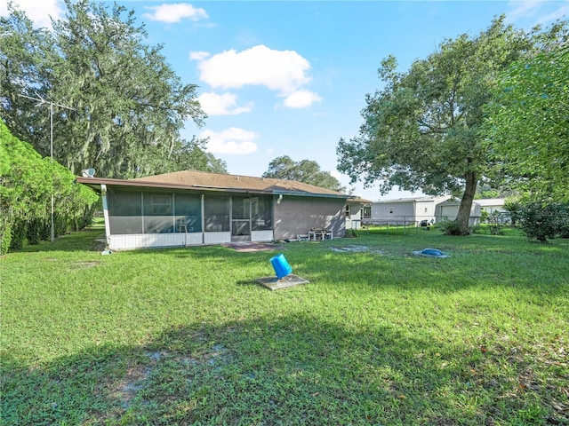 5337 Jacob Ave, Polk City, FL 33868 - back of property featuring a sunroom and a lawn
