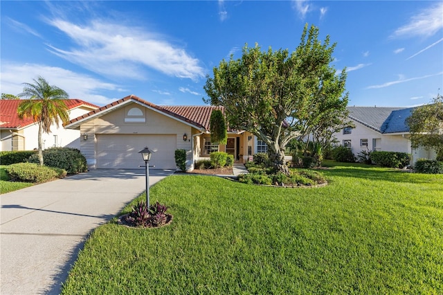 view of front of home with a front yard and a garage