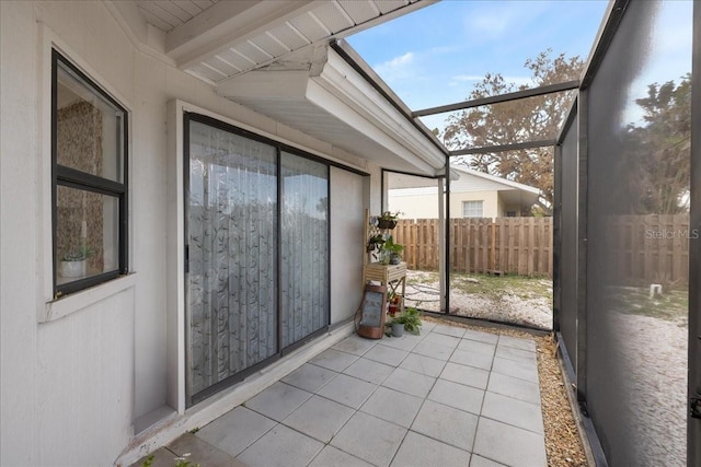 unfurnished sunroom with beamed ceiling