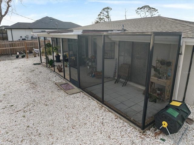 back of property with a patio and a sunroom