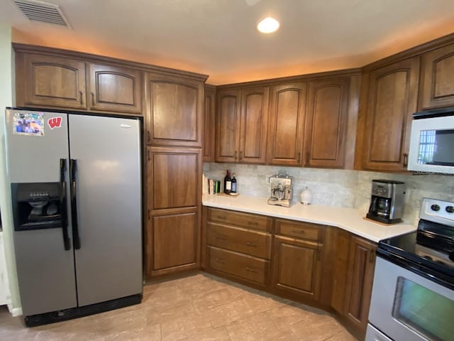 kitchen with backsplash and white appliances