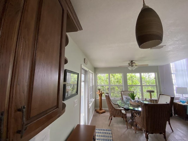 sunroom featuring ceiling fan