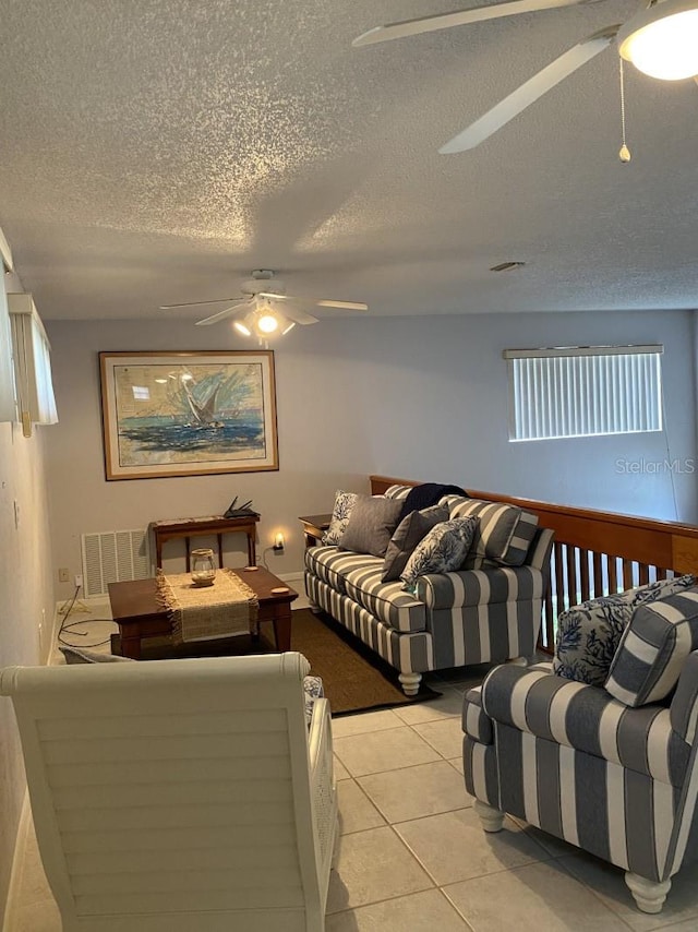 living room featuring light tile patterned floors and a textured ceiling