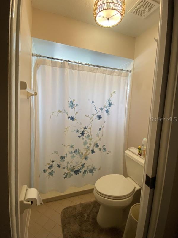 bathroom featuring tile patterned flooring and toilet