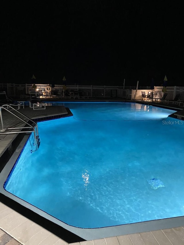 view of pool at night