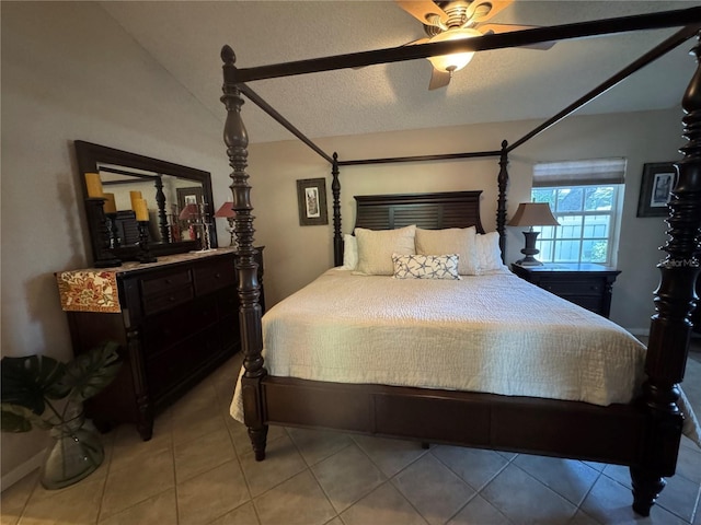 20 Bristol Ln, Palm Coast, FL 32137 - bedroom with vaulted ceiling, light tile patterned flooring, ceiling fan, and a textured ceiling