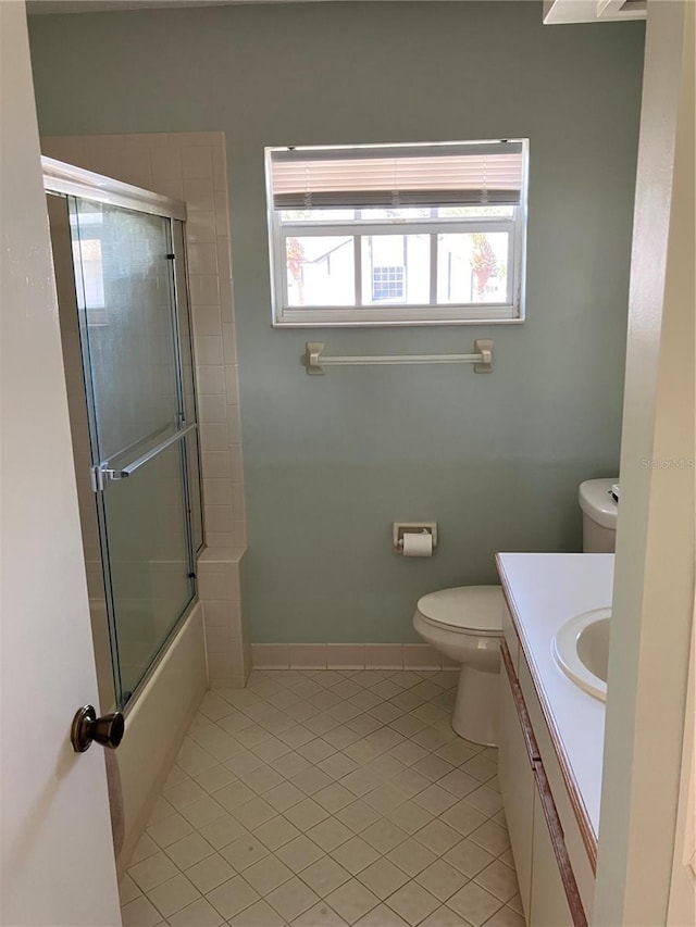 20 Bristol Ln, Palm Coast, FL 32137 - full bath featuring toilet, tile patterned flooring, vanity, and shower / bath combination with glass door