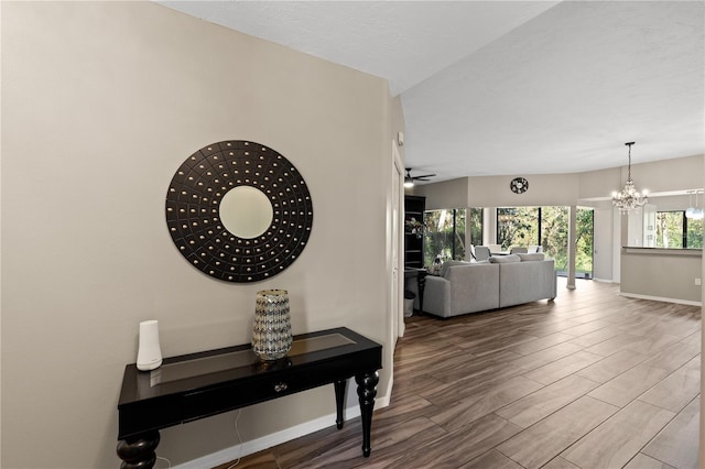 hallway with a chandelier, hardwood / wood-style floors, and a healthy amount of sunlight