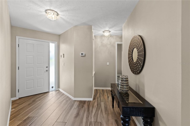 entrance foyer with a textured ceiling and hardwood / wood-style floors