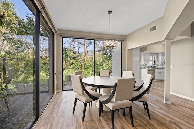 dining room featuring an inviting chandelier and light wood-type flooring