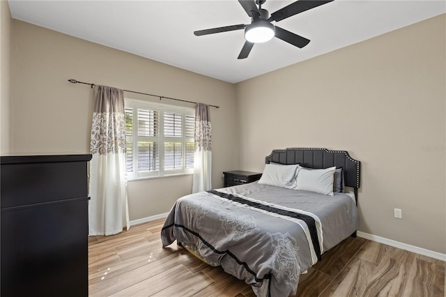 bedroom with ceiling fan and light hardwood / wood-style flooring