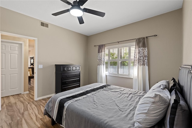 bedroom with light hardwood / wood-style floors and ceiling fan