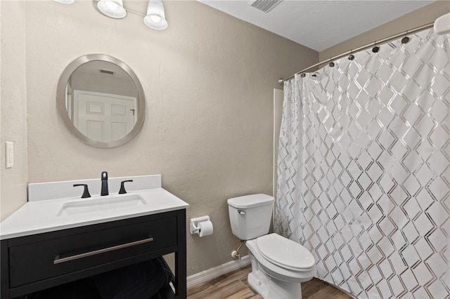 bathroom featuring vanity, hardwood / wood-style floors, a shower with shower curtain, and toilet