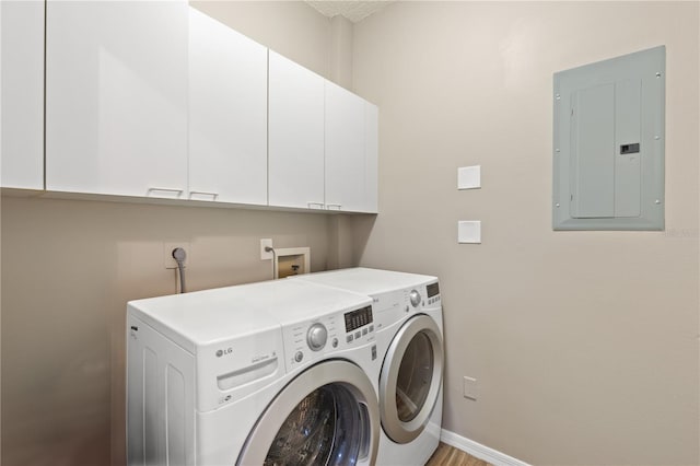 washroom featuring cabinets, independent washer and dryer, and electric panel