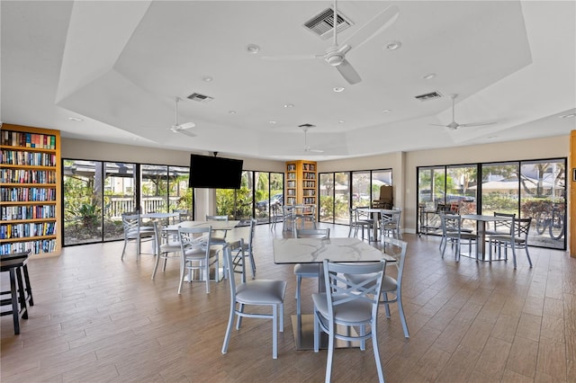 dining room with light wood-type flooring and ceiling fan