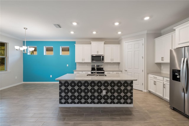 kitchen featuring white cabinetry, appliances with stainless steel finishes, sink, and a center island with sink