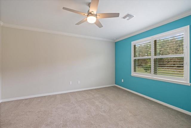 spare room featuring crown molding, light colored carpet, and ceiling fan