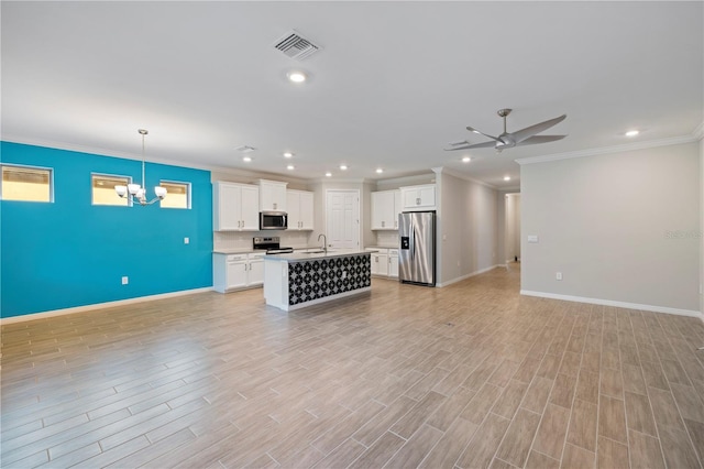 kitchen featuring white cabinetry, a kitchen island with sink, pendant lighting, light hardwood / wood-style floors, and stainless steel appliances