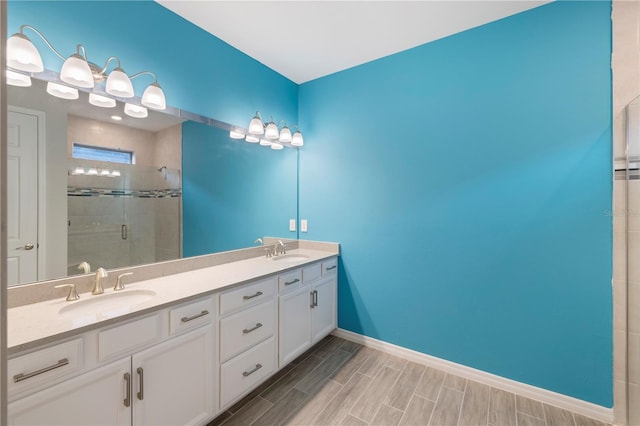 bathroom with a shower with door and vanity