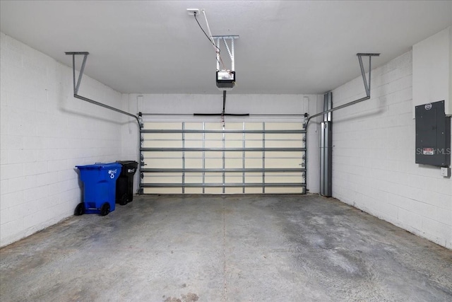 garage with a garage door opener and electric panel