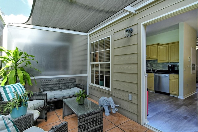 balcony with a patio, sink, and an outdoor living space