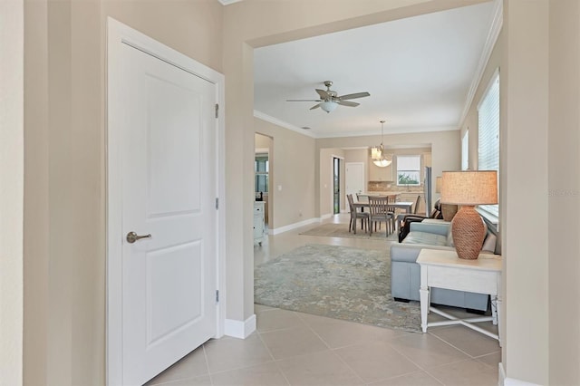 living room featuring ceiling fan, light tile patterned floors, and crown molding